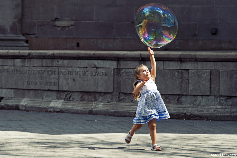 little girl catching big bubble